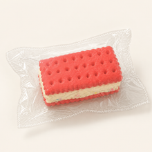 NOLLUMI Dopamine Sandwich Cookie Squishy in its clear sealed wrapper, with coral biscuit layers and sprinkle cream filling