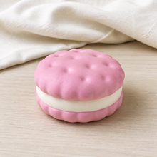 Real product photo of the NOLLUMI Sandwich Cookie Squishy in Strawberry Pink on ivory linen and light wood